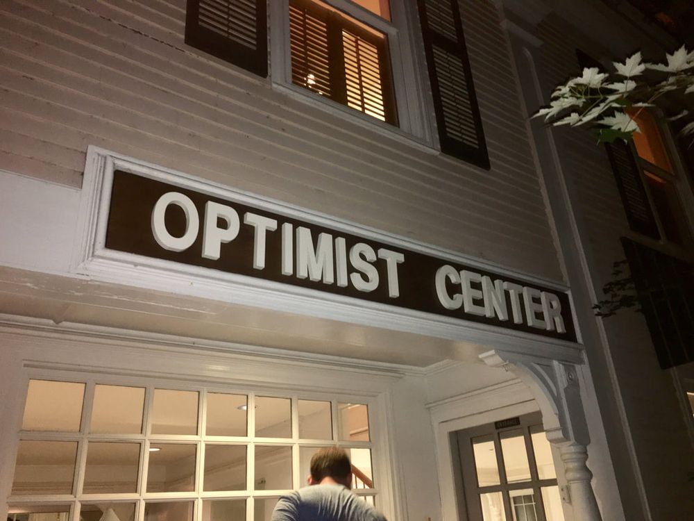 The Optimist Center sign above the storefront windows